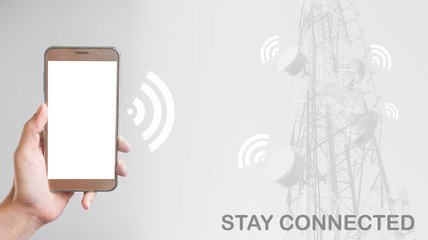 Holding a smartphone on grey background and antenna with stay connected text, social networking concept
