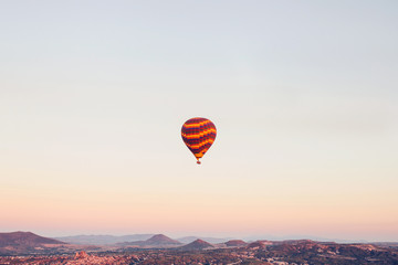 Flight of a lonely balloon in the sky in the morning at sunrise or in the evening at sunset. Travel...