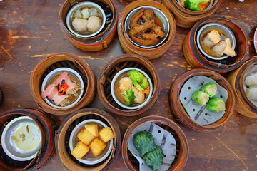 The Chinese food ,A many kind of Dim Sum in bamboo basket on table in chinese food restaurant.