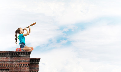 Concept of careless happy childhood with girl exploring this world