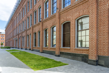 Fototapeta na wymiar Office building in loft style. large Windows. Red brick wall.