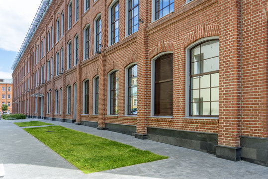 Fototapeta Office building in loft style. large Windows. Red brick wall.