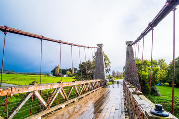Clifden suspension bridge after a raining day. New Zealand.
