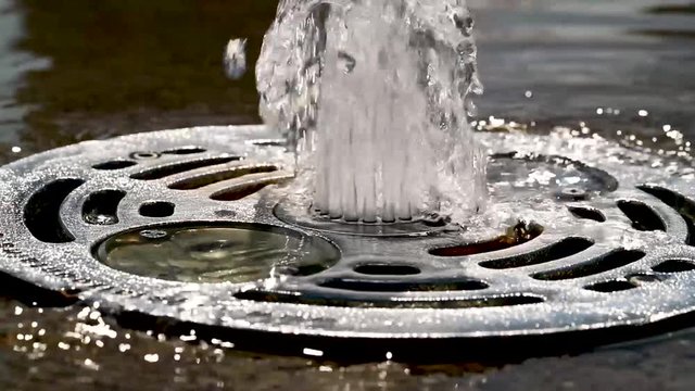 Water fountain in summer. Slow motion of water drop.