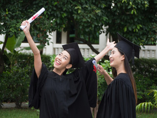 Graduation Friend Celebrate Degree Concept.Beautiful Asian university graduates celebrate their success.