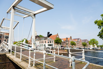 Traditional Dutch houses along a canal on a sunny day in Haarlem in the Netherlands, Europe