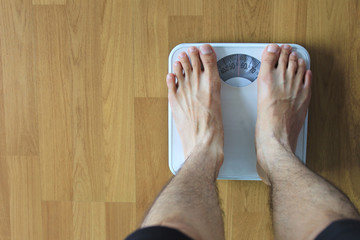 Male on the weight scale for check weight, Diet concept