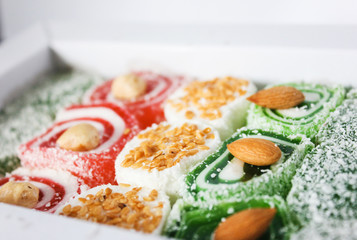 Turkish delight. Turkish dessert at close range. Lokum or rahat lokom with peanuts, almonds, sesame.