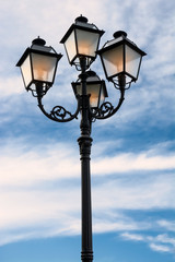 Fototapeta na wymiar Street lamp lit at dusk