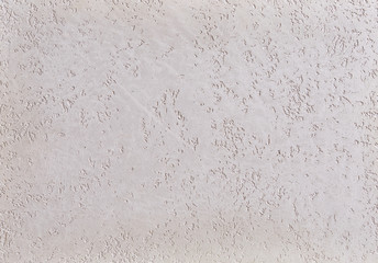 Fototapeta premium Close-up surface detail of old rough white plaster wall texture, macro.