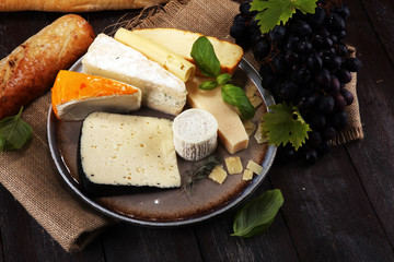 Cheese platter with different cheese on rustic plate