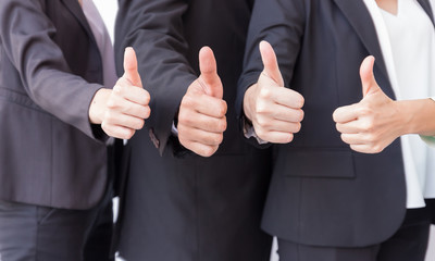 Business team with thumbs up for agreement sign with success business concept.