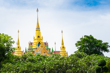 Naklejka premium View of Wat Tang Sai or Pramahatart Chedi Pakdepragard in Baan Grood Beach,Bang Saphan, Prachuap Khirikhan Thailand. Beautiful large golden Buddha temple and garden.