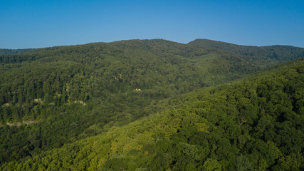 Russian Forest And Mountains Under Blue Sky By Aerial Drone. Stunning Aerial Drone Stock Footage of South russian Forest And Mountains Under Blue Sky