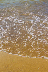 Soft wave of the sea on the sandy beach