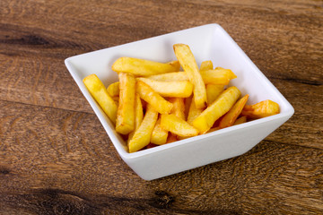 French potato over wooden background