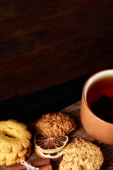 Christmas teatime with oatmeal, chocolate biscuits, and spices, on wooden background, close-up, selective focus.