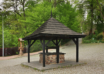Draw-well near Church of St. John the Baptist in Naleczow. Swietokrzyskie Voivodeship. Poland