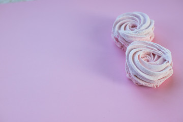 Pink homemade zephyr or marshmallow on pink background. Marshmallow, Meringue, Zephyr.Candy cakes concept. zephyr, souffle ,homemade meringue