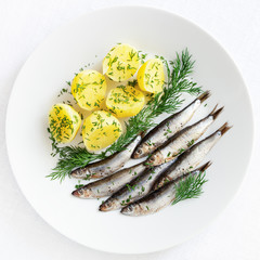 freshly salted sprats with boiled potato and dill