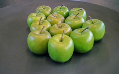 Green apples at gray background still life