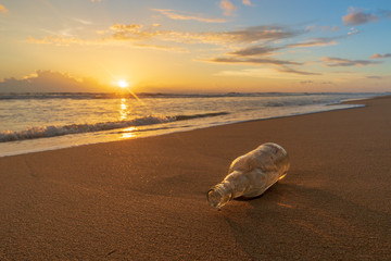 Glass bottle with beatiful beach sunset landscape