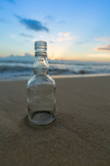 Glass bottle with beatiful beach sunset landscape