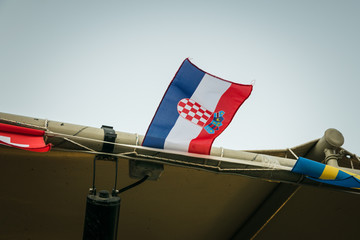 Small croatian flag fluttering on the wind, against blue sky.  Croatia is one of the World Cup...