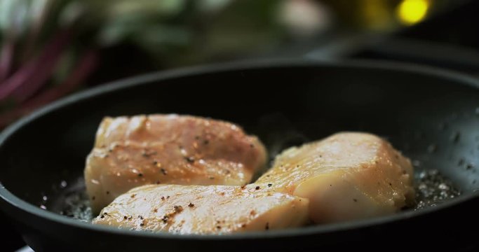 Professional chef in a modern restaurant is preparing cod fillet
