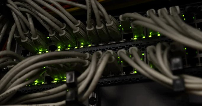 Details of a storage array in a modern data center with lot of connectors and blinking leds