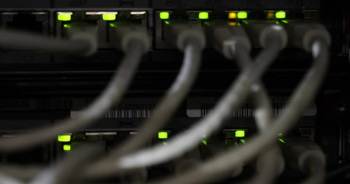 Details of a storage array in a modern data center with lot of connectors and blinking leds