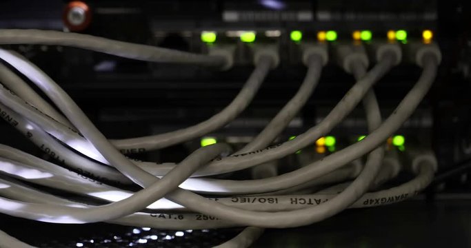 Details of a storage array in a modern data center with lot of connectors and blinking leds