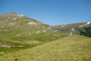 View of Bucegi Mountains, Bucegi National Park, Romania, clear blue sky, few clouds, sunny summer day, perfect for hiking