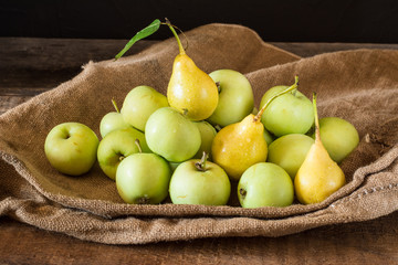 Ripe red and green apples on wooden background. Apples in bowl. Garden fruits. Autumn fruits. Autumn harvest. Yellow pears