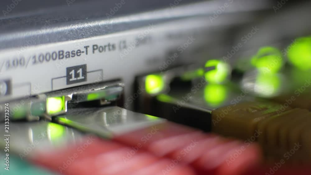 Poster macro shot of a server with flashing green lights for connection and lot of internet cables
