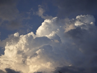 Fototapeta na wymiar Beautiful cumulus clouds against the blue sky, lit by the sun