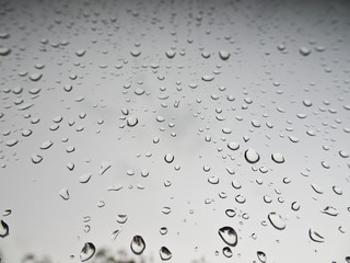 Large drops of rain on the windshield of the car