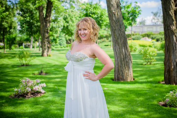 Beautiful plus size bride at park in her wedding. Wedding concept 