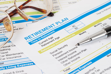 Retirement plan with glasses and pen, document is mock-up