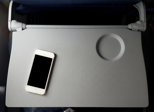 Airplane Tray Table On Seat Back With Smartphone