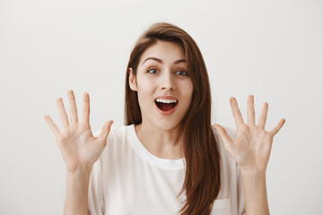 Calm down, everything is okay, no need to cry. Portrait of worried pleasant female friend holding raised palms and smiling nervously, trying to comfort upset girlfriend, going crazy cause of breakup