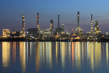 Bangchak Petroleum's oil refinery reflection in the Chao Phraya River with sunrise ,Bangkok, Thailand