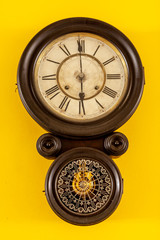 Vintage clock with bright yellow background