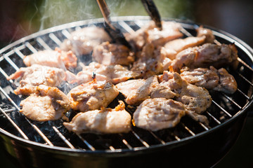 Spicy marinated chicken wings grilling on a summer barbecue outdoor 