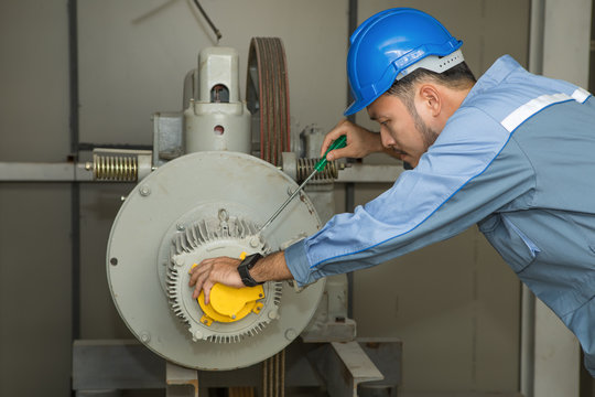 Maintenance engineer repairing lift Motor for elevators