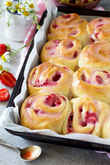 Fresh Homemade Rolls Buns with strawberry with Cream Cheese in glaze for Breakfast  on a stone or slate gray background.