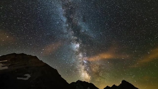 Astro Time Lapse Milky way galaxy stars rotating over the Alps, motion clouds, scenic mountain peak and cliff, Jupiter planet right and Mars planet left, slider