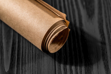 yellow kraft paper isolated on a black wooden background