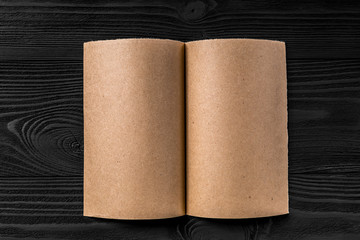 yellow kraft paper isolated on a black wooden background