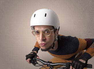 Nerd young foolish biker on a bike with oldschool outfit